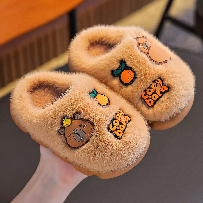 Pair of tan capybara slippers showing fluffy lining and decorative charms