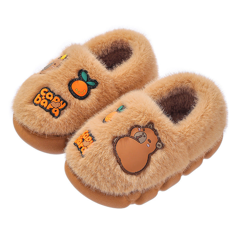 Tan fluffy capybara slippers with citrus decorations on a white background